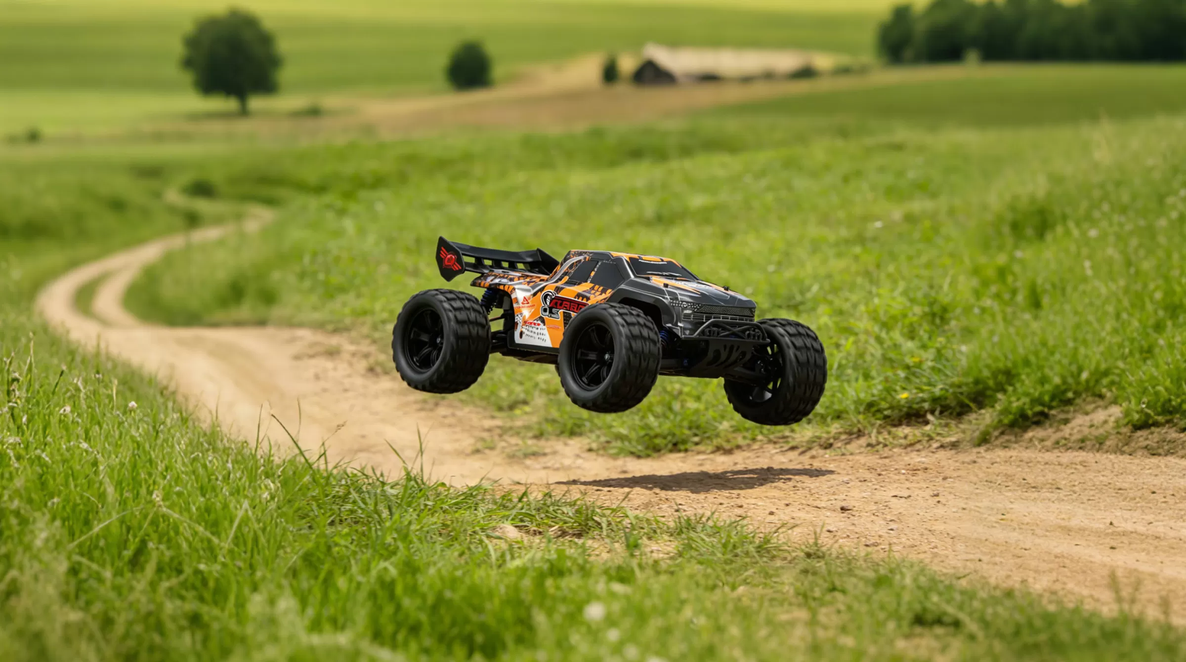 electric-rc-truggy-driving-through-grass-dirt-and-performing-jumps.jpg